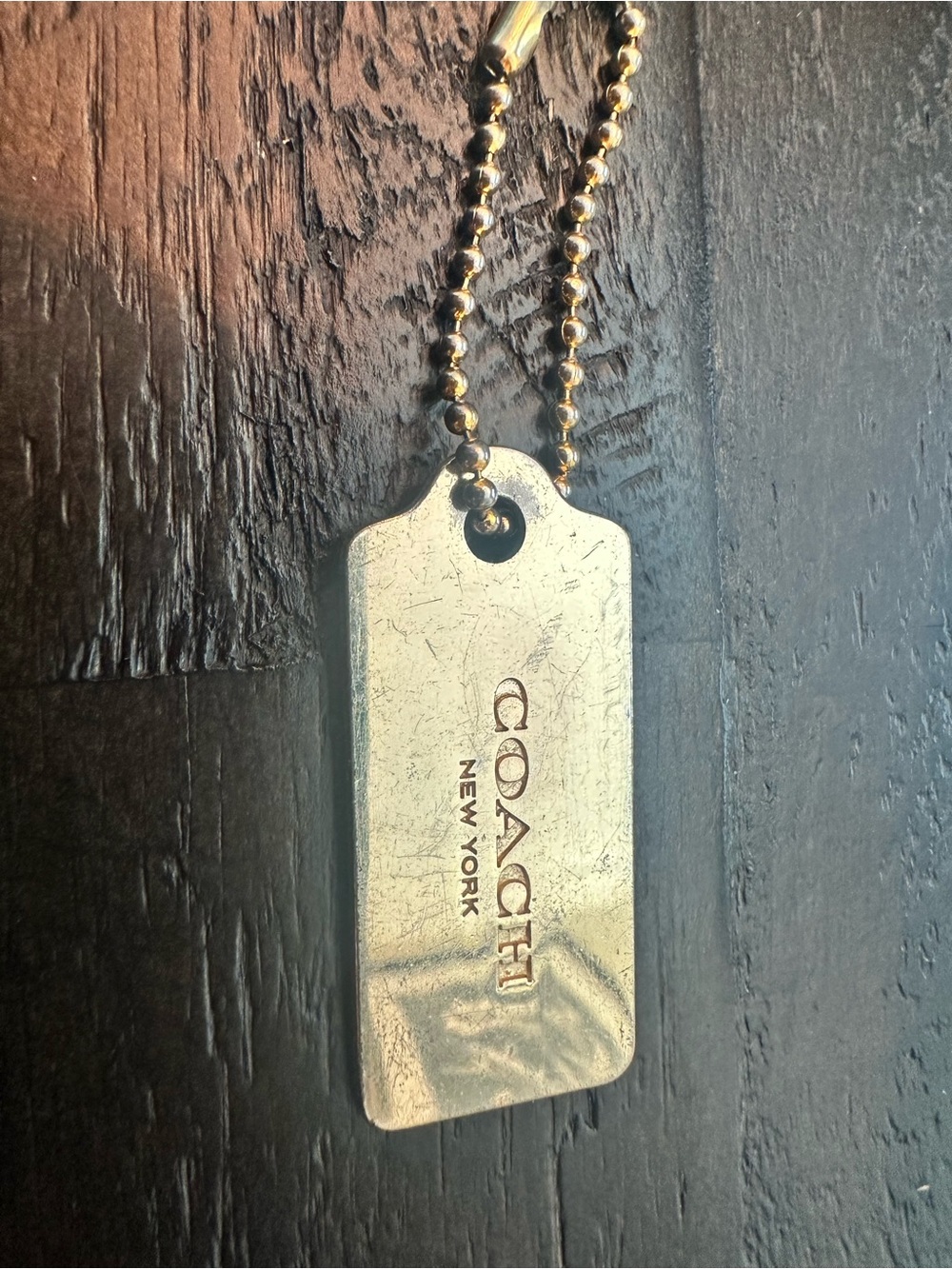 Coach Gold-Tone Engraved Bag  Tag Pendant - has some scratches